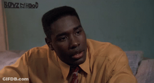 Man In Yellow Shirt And Tie Sitting By Boyz N The Hood Poster GIF