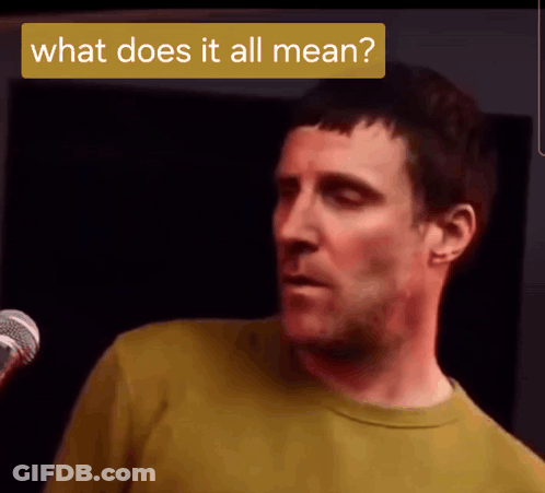 Man In Yellow Shirt At Microphone Saying What Does It All Mean GIF