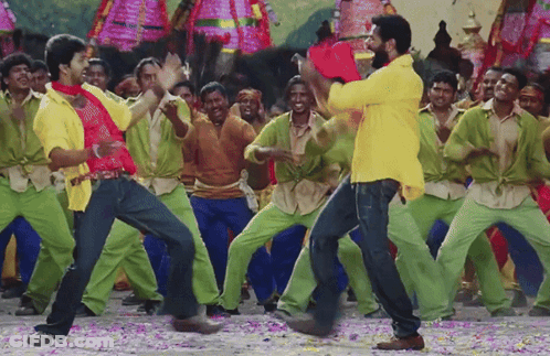 Man In Yellow Shirt Dancing Before Green Pants Crowd GIF