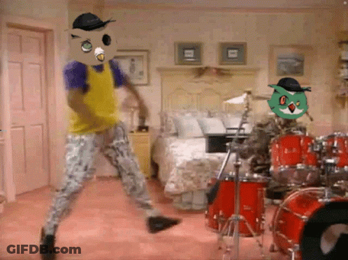 Man In Yellow Shirt Dancing In Front Of Drum Set GIF