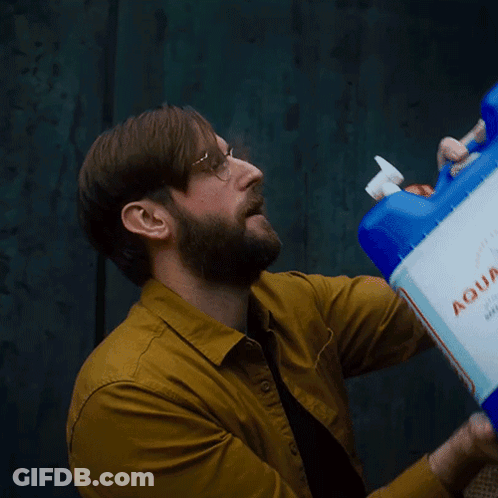 Man In Yellow Shirt Drinking Blue Xtra Container GIF