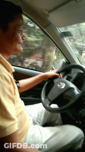 Man In Yellow Shirt Driving Car GIF
