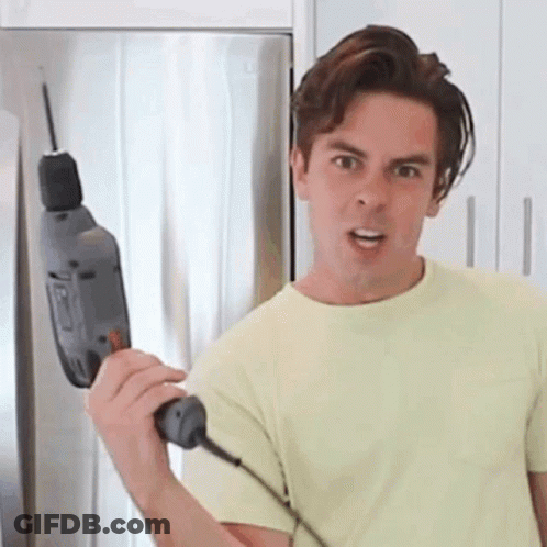 Man In Yellow Shirt Holding Drill GIF