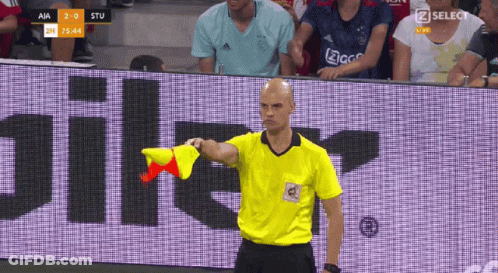 Man In Yellow Shirt Holding Red Flag Saying Zselect GIF