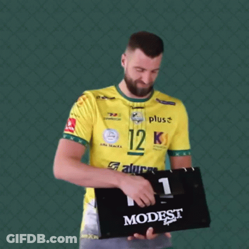 Man In Yellow Shirt Holding Scoreboard Saying Modest GIF