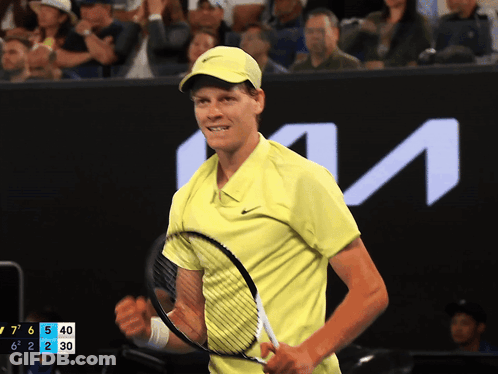 Man In Yellow Shirt Holding Tennis Racquet KTM Sign GIF