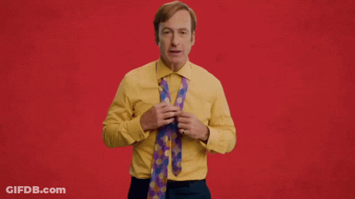 Man In Yellow Shirt Holding Tie Snappy GIF