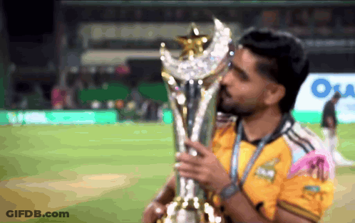 Man In Yellow Shirt Holding Trophy GIF