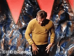 Man In Yellow Shirt In Front Of Red And Blue Wall GIF
