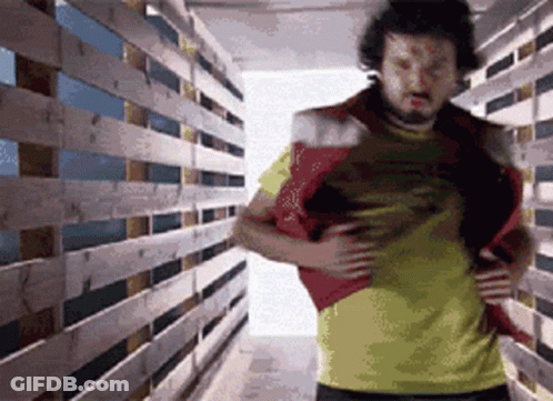 Man In Yellow Shirt In Wooden Hallway GIF