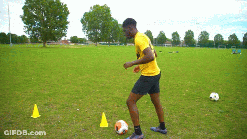 Man In Yellow Shirt Kicking Soccer Ball GIF