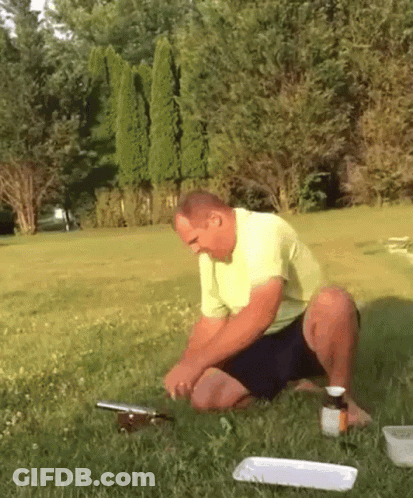 Man In Yellow Shirt Kneeling With Medicine GIF