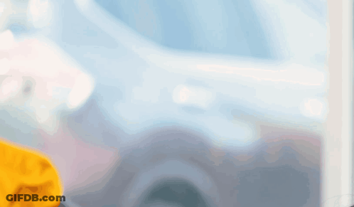 Man In Yellow Shirt Looking Out Window GIF