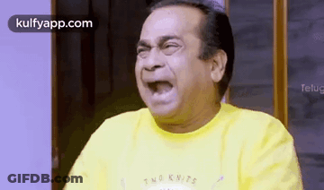 Man In Yellow Shirt Making Funny Face With Mouth Open GIF