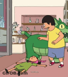 Man In Yellow Shirt Next To Green Dinosaur GIF
