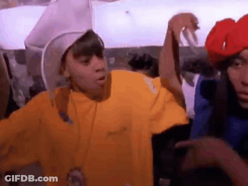 Man In Yellow Shirt Next To Man In Red Hat And Woman In Blue Shirt GIF
