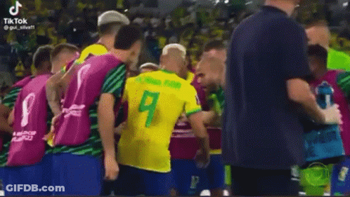 Man In Yellow Shirt Next To Man In Red GIF