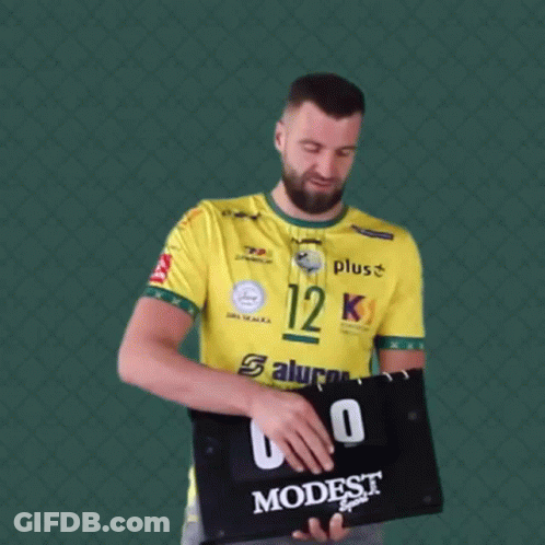 Man In Yellow Shirt Number 12 Holding Scoreboard GIF