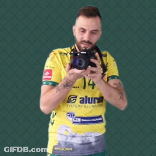 Man In Yellow Shirt Number 14 Taking Selfie GIF