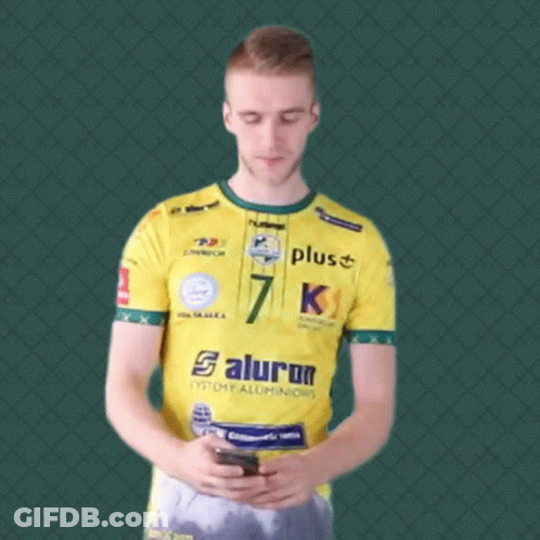 Man In Yellow Shirt Number 7 Looking At Phone GIF
