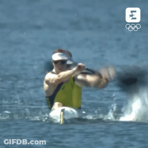 Man In Yellow Shirt Paddling Kayak With Olympics Logo GIF