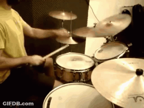 Man In Yellow Shirt Playing Drums With LC Cymbal GIF