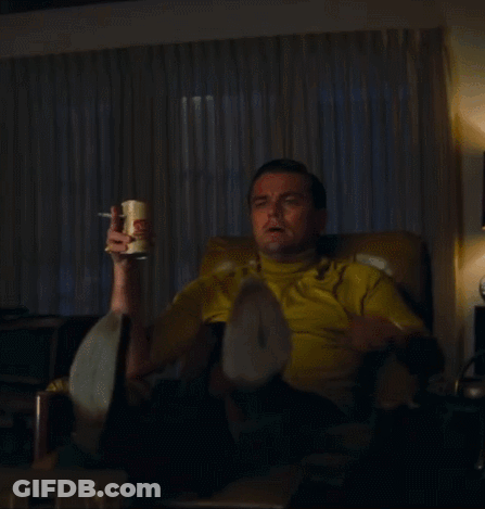Man In Yellow Shirt Pointing While Sitting GIF