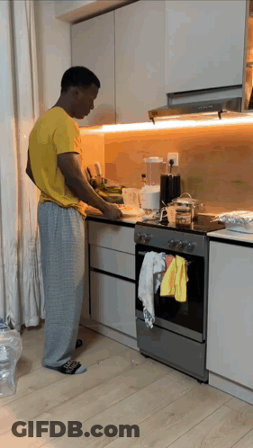 Man In Yellow Shirt Preparing Food GIF