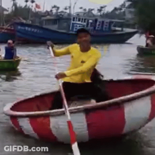 Man In Yellow Shirt Rowing Red And White Boat GIF