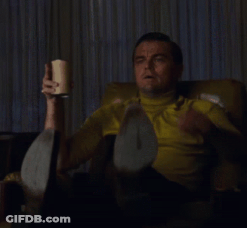 Man In Yellow Shirt Sitting And Pointing GIF