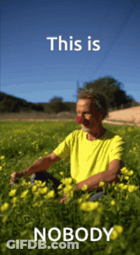 Man In Yellow Shirt Sitting In Yellow Flowers This Is Nobody GIF
