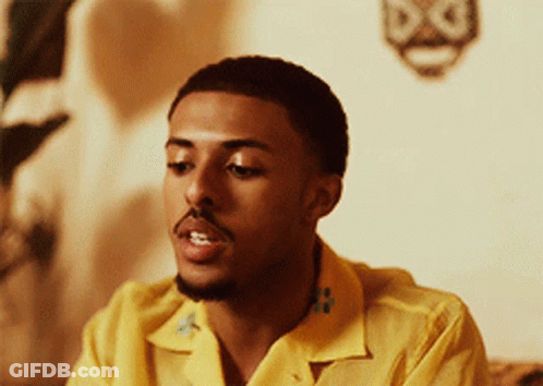 Man In Yellow Shirt Sitting On Couch GIF