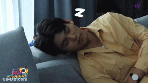 Man In Yellow Shirt Sleeping On Couch With Letter N GIF