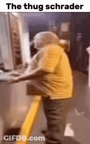 Man In Yellow Shirt Standing At Computer Captioned The Thug Schrader GIF