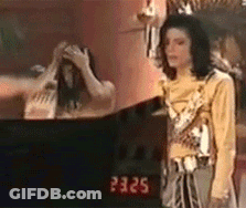 Man In Yellow Shirt Standing At Mirror GIF