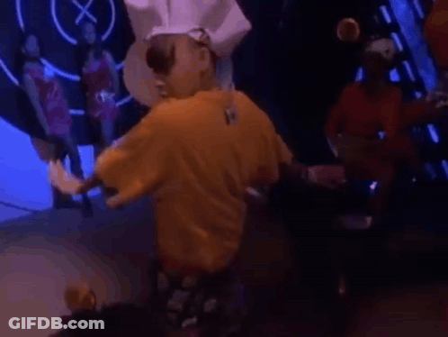 Man In Yellow Shirt Standing Before Crowd GIF