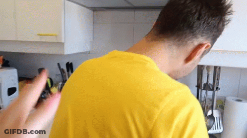 Man In Yellow Shirt Standing In Kitchen GIF