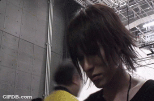 Man In Yellow Shirt Standing Next To Woman With Long Hair GIF