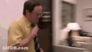 Man In Yellow Shirt Talking On Cell Phone By Fridge GIF