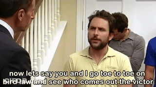 Man In Yellow Shirt Talking To Man In Suit While Another Watches GIF