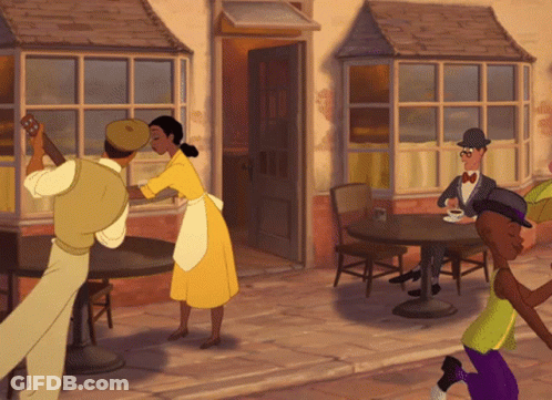 Man In Yellow Shirt Talking To Woman In Black Top GIF