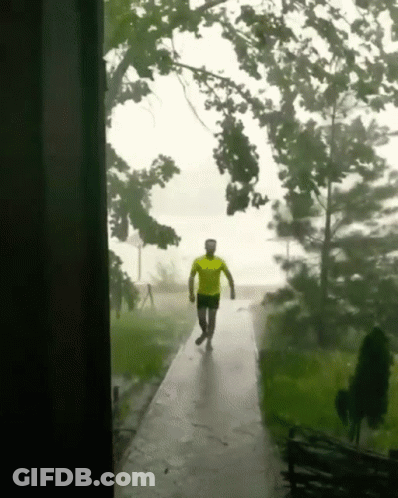 Man In Yellow Shirt Walking In Rain GIF