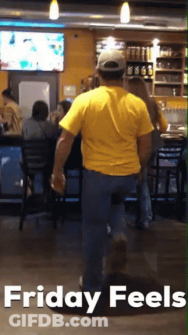 Man In Yellow Shirt Walking Through Restaurant GIF