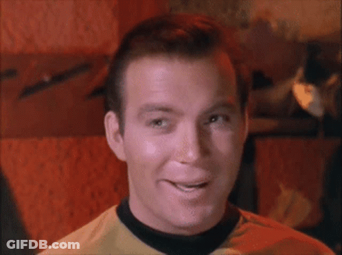 Man In Yellow Shirt With Black Collar Smiling GIF