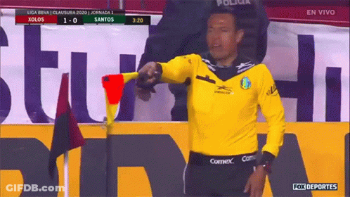 Man In Yellow Shirt With COMEX On Shorts GIF