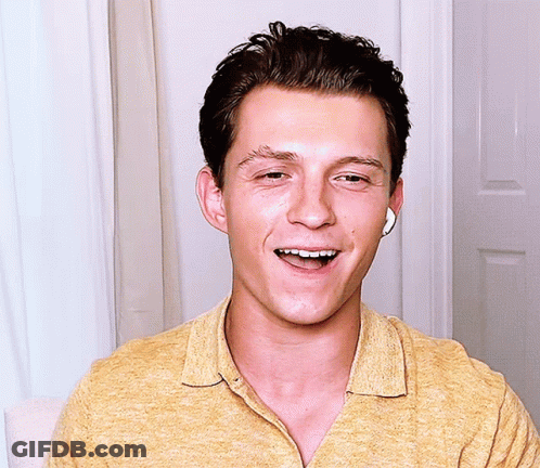 Man In Yellow Shirt With Earbuds Smiling Eyes Closed GIF