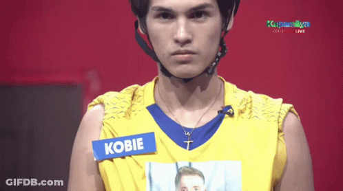 Man In Yellow Shirt With Kobie Tag GIF