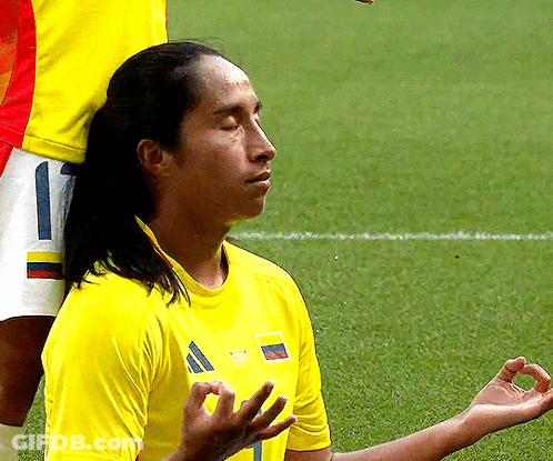 Man In Yellow Shirt With Number 1 Meditating GIF