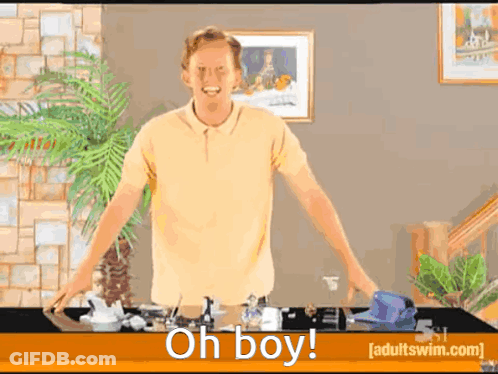 Man In Yellow Shirt With Oh Boy Table GIF