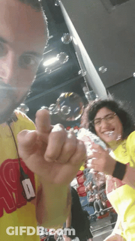 Man In Yellow Shirt With R Giving Middle Finger GIF